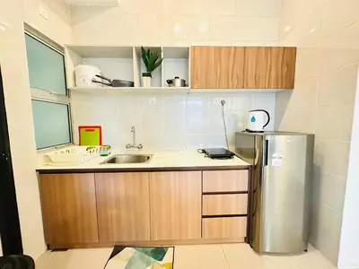 a kitchen with a stainless steel refrigerator and a sink at Homestay Golden Hills in Brinchang