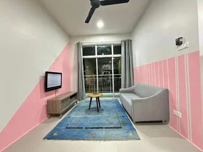 a living room with a couch and a tv at Homestay Golden Hills in Brinchang