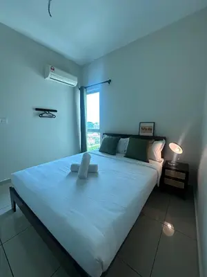 a large white bed in a room with a window at Metropol by BRB in Bukit Mertajam