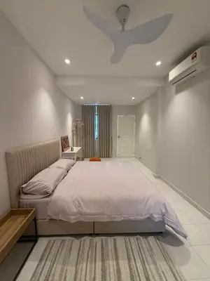 a bedroom with a large bed and a ceiling fan at Taman Bagan Homestay in Butterworth