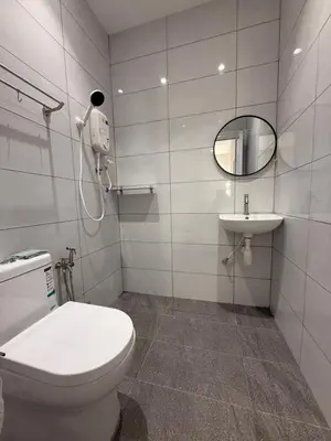 a bathroom with a toilet and a sink at Taman Bagan Homestay in Butterworth