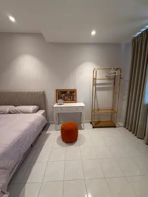 a bedroom with a bed and a table with a pumpkin on the floor at Taman Bagan Homestay in Butterworth