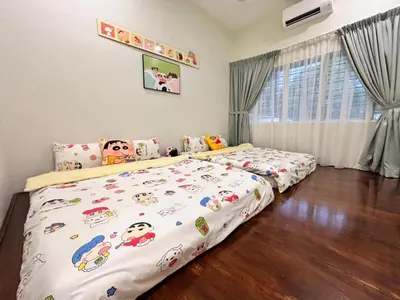 a bedroom with two beds with hello kitty sheets at The Crayon Shin-chan Themed Stay Family Ipoh By LUX SUITE in Ipoh
