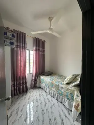 a bedroom with a bed and a ceiling fan at RJ Homestay Bandar Utama Gua Musang in Gua Musang