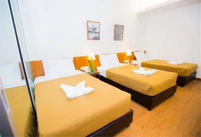 a room with two beds with white butterflies on them at Urban Inn Kulim in Kulim