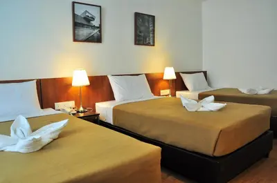 a hotel room with two beds with white pillows at Urban Inn Kulim in Kulim