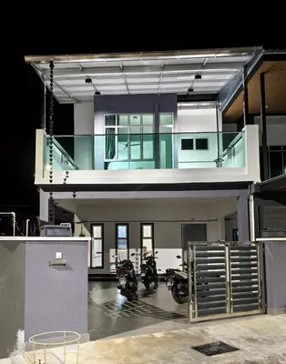 a house with two motorcycles parked in a garage at Hello Pangkor Home 77 - A Nest for 15 buddies in Pangkor