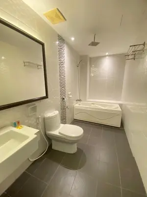 a bathroom with a toilet and a sink and a tub at Mak Sa'adiah Hotel in Kampung Teluk Nipah