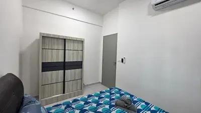 a bedroom with a bed and a cabinet in it at NEW Bt Kawan8 3BR Suite-IKEA-UOW-KDU-ColumbiaAsia in Simpang Ampat