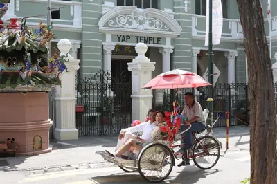 a group of people riding in a horse drawn carriage at Soori Penang in George Town