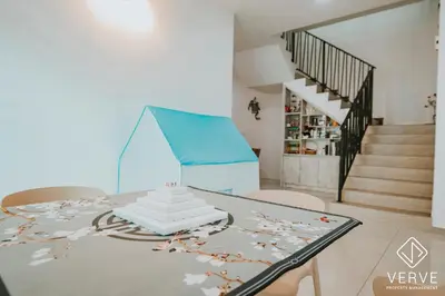 a dining room with a table and a staircase at Ipoh Gateway by Verve 4R4B - 14 Pax in Ipoh