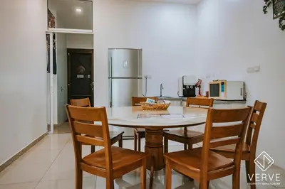 a kitchen with a table and chairs and a refrigerator at Ipoh Gateway by Verve 4R4B - 14 Pax in Ipoh