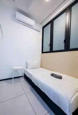a bedroom with two beds and two windows at Urban Suites Jelutong Georgetown Penang 6pax 3BR Family Cozy Homestay in George Town