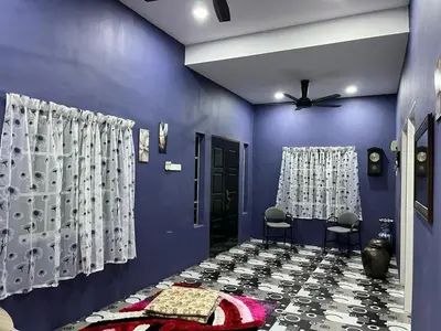a blue room with two chairs and a ceiling fan at Homestay ABAH in Nibung Tebal
