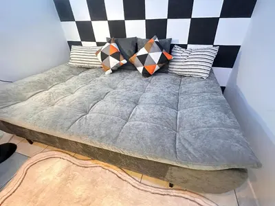 a bed with pillows on it in a room at Unisuites Kampar Studio UTAR TARC -3pax, Pet Friendly, FREE 1 Carpark & Netflix in Kampar