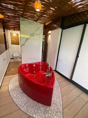 a bathroom with a red bath tub in a room at Rumah Inap Kampung Agong Sunrise in Penaga