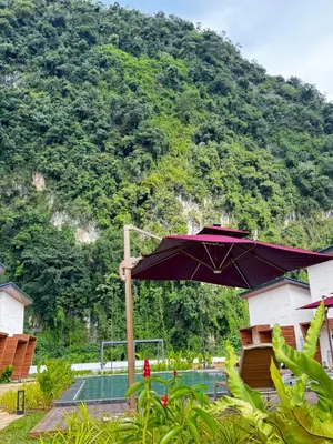 an umbrella in front of a mountain at Tambuna Retreat ,TAMBUN ,IPOH in Tambun