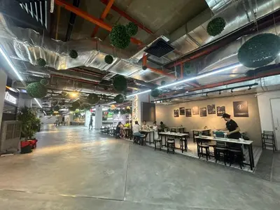 a room with people sitting at tables in a restaurant at Modern Cozy Seaview Entire Suites 118 Island Plaza in George Town