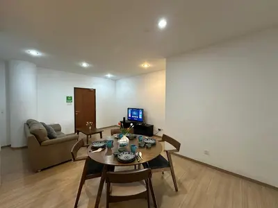 a living room with a table and a couch at Modern Cozy Seaview Entire Suites 118 Island Plaza in George Town