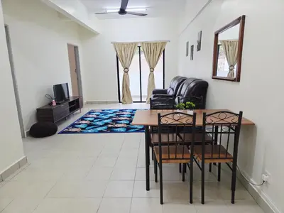 a living room with a dining room table and chairs at QaiDaff Homestay CH in Cameron Highlands