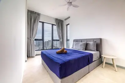 a bedroom with a bed with a blue blanket and a window at M22 #CityView SeaView #Georgetown #35 in George Town