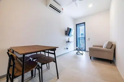 a dining room with a table and chairs and a couch at M22 #CityView SeaView #Georgetown #35 in George Town