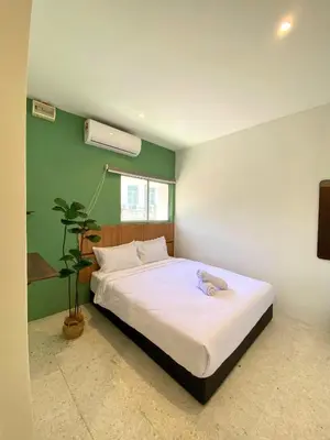 a bedroom with a bed with a stuffed animal on it at Sembilan Inn by Soft Loft in George Town