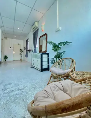 a room with chairs and a mirror and a dresser at Sembilan Inn by Soft Loft in George Town