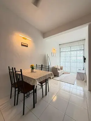 a dining room with a table and chairs and a couch at SZ Homestay Near KPJ Hospital in Kampong Permatang Batu