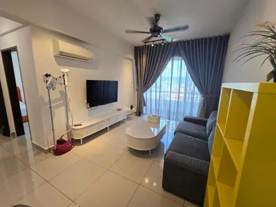 a living room with a couch and a tv at The Majestic Privilege Suites - Ipoh in Ipoh
