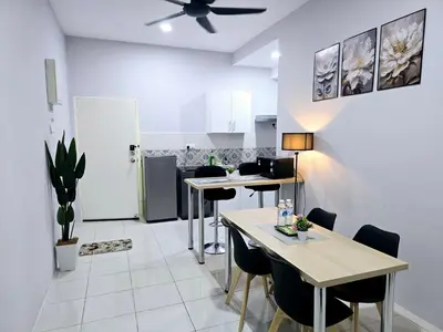 a living room with tables and chairs and a ceiling fan at b09 The Anderson Ipoh Family Stay 2BR in Ipoh