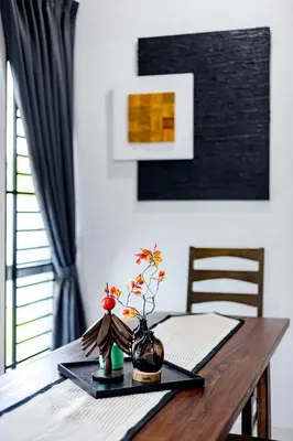 a wooden table with a vase on top of it at i Homes Villa 3 Nearby Sunway - Swimming Pool and Karaoke in Ipoh