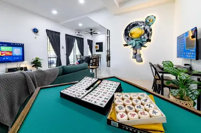 a living room with a table with a tv at i Homes Villa 3 Nearby Sunway - Swimming Pool and Karaoke in Ipoh