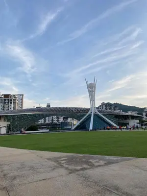 a building with a sculpture in the middle of a field at Easy Access to Airport, USM & Queensbay in Bayan Lepas
