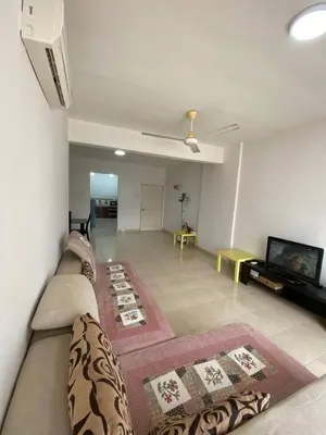 a living room with a couch and a tv at Easy Access to Airport, USM & Queensbay in Bayan Lepas