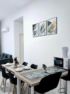 a dining room with a table and chairs at d10 The Anderson Ipoh Family Stay 2BR in Ipoh
