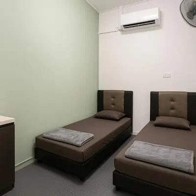 a room with two beds and a air conditioner at TK Homie in Tanjung Karang