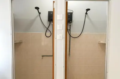 a bathroom with a shower and a mirror at TK Homie in Tanjung Karang