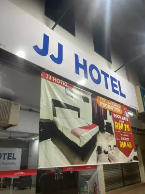 a sign for a hotel with a bed on display at JJ Hotel Sitiawan Perak in Sitiawan