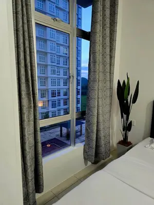 a bedroom with a window with a view of a building at b04 The Anderson Ipoh Family Stay 2BR in Ipoh
