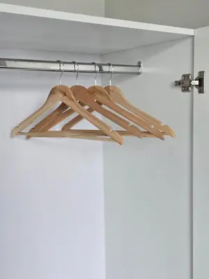 a group of wooden hangers hanging from a door at b04 The Anderson Ipoh Family Stay 2BR in Ipoh