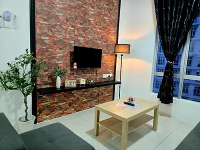 a living room with a brick wall and a table at b04 The Anderson Ipoh Family Stay 2BR in Ipoh