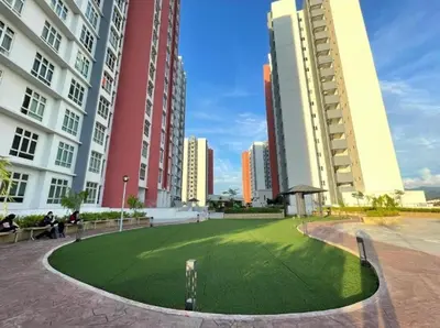 a grassy area in a city with tall buildings at c02 The Anderson Ipoh Family Stay 2BR in Ipoh