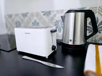 a toaster sitting on top of a black counter at a06 The Anderson Ipoh Family Stay 2BR in Ipoh