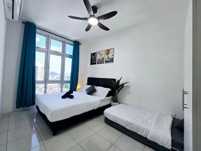 a bedroom with two beds and a ceiling fan at a06 The Anderson Ipoh Family Stay 2BR in Ipoh