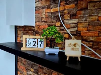a table with a clock and a plant on it at d01 The Anderson Ipoh Family Stay 2BR in Ipoh