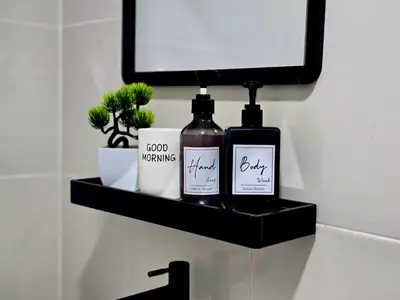 a bathroom shelf with two bottles of soap and a mirror at b03 The Anderson Ipoh Family Stay 2BR in Ipoh