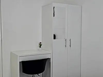 a white desk with a chair next to a cabinet at b06 The Anderson Ipoh Family Stay 2BR in Ipoh
