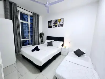 two beds in a white room with a window at b02 The Anderson Ipoh Family Stay 2BR in Ipoh