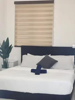 a large white bed with a black head board at b02 The Anderson Ipoh Family Stay 2BR in Ipoh